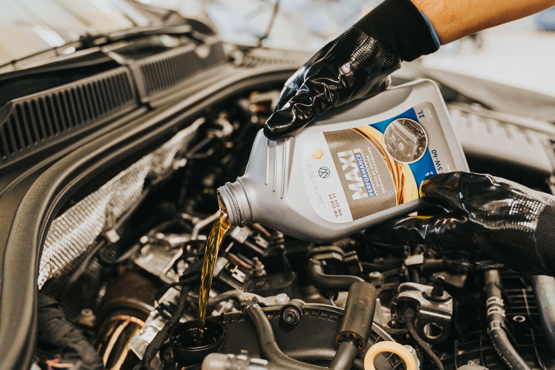 Professional mechanic performing oil change service